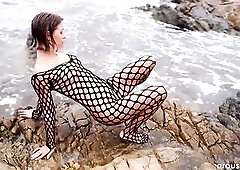 Arousins.com episode! Avery stands on a rocky coastline in a fishnet bodysuit, brunette damp from the sea spray. Have a fun the full 4k episode at Aro