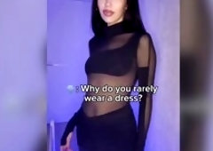 Curves hug constricted ebony fabric beneath blue light ?